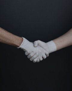 Poignée de main avec des gants : Tisser de nouveaux partenariat pour vendre ses produits en ligne
